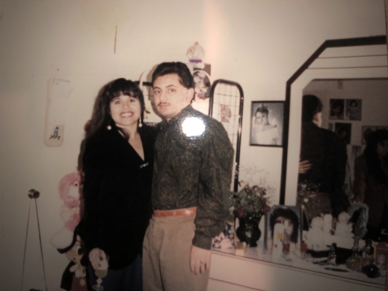 Isaura and David pose for a picture in thier bedroom.