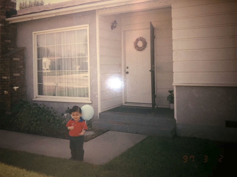 Little David is posing in front of the family's West Covina home, holding a blue ballon.