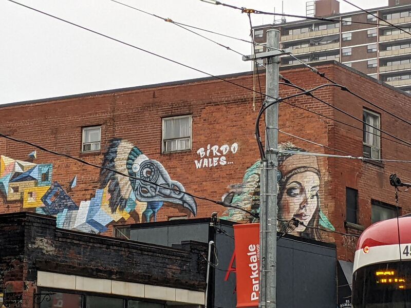 Painting on side of brick building depicting an Indigenous woman