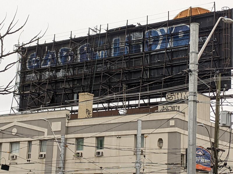 Blue tags on the back of a billboard.