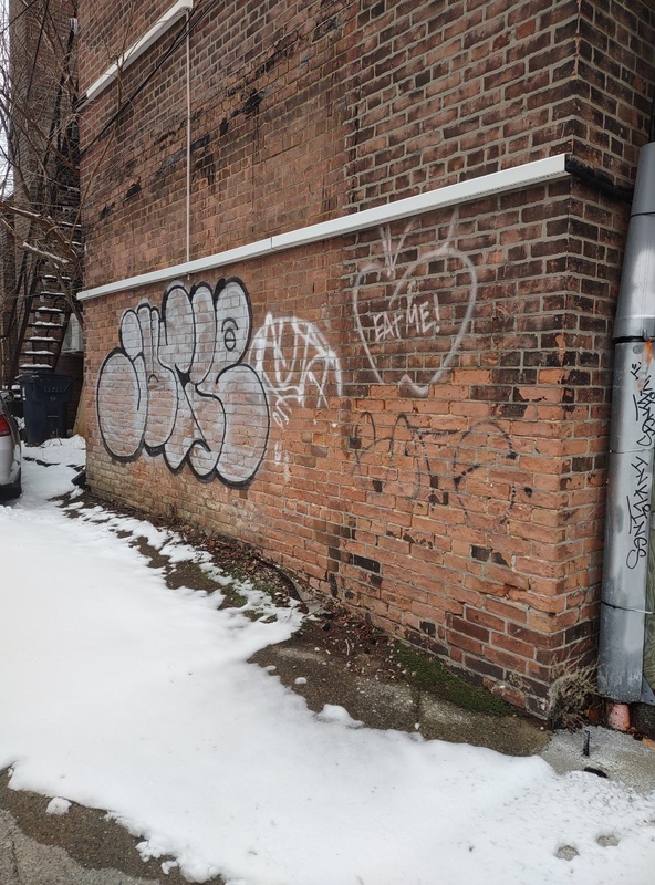 Graffiti tags and an apple that says 'EAT ME'