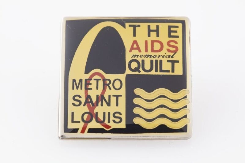 color photorgraph of an AIDS memorial quilt pin; pin reads "The AIDS memorial quilt... Metro Saint Louis"